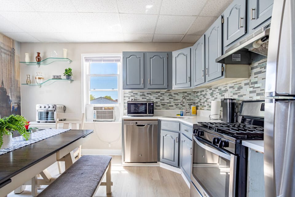 Full kitchen — fridge, gas range, dishwasher, microwave, coffee maker, all the tools.