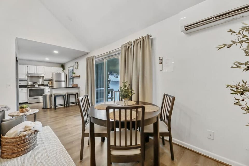 The dining area features a sleek table with four comfy seats.
