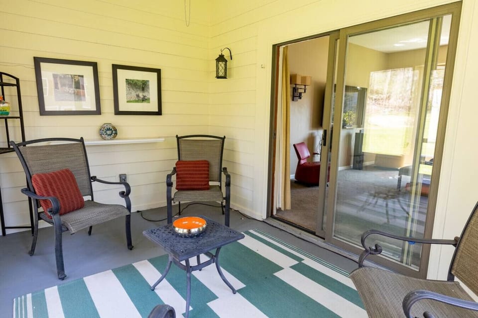 Patio with chairs and table perfect for an afternoon relaxation.