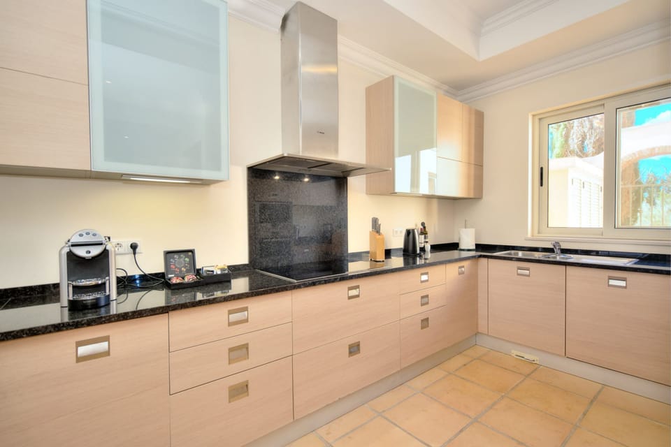 Kitchen with fitted appliances