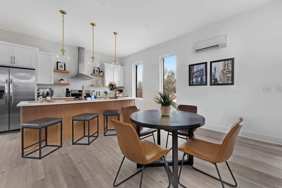 Clean and Spacious Kitchen with Sleek Countertops and Additional Seating