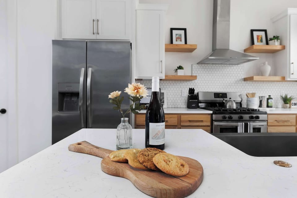 Clean and Spacious Kitchen with Sleek Countertops and Additional Seating