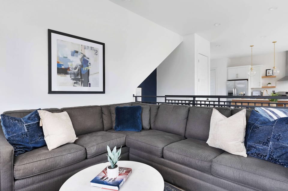 Spacious living room featuring a television, a large sectional sofa, and a pull-out sofa bed for added comfort and flexibility.