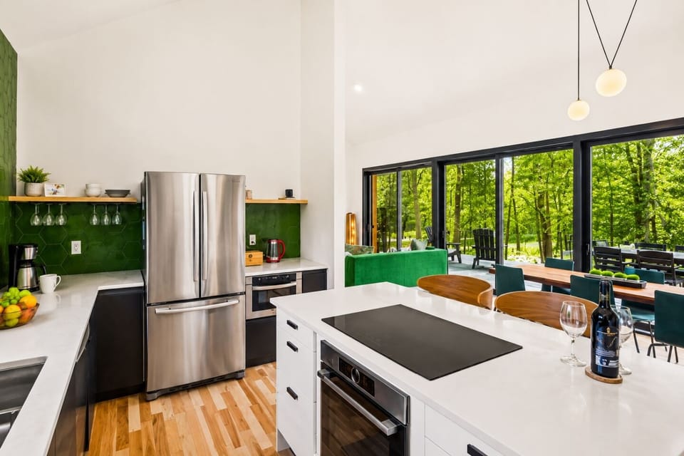 Experience a vibrant, refreshing kitchen where nature meets modern design. This stunning space features a bold green accent wall that brings a sense of calm and rejuvenation to the heart of your home. 