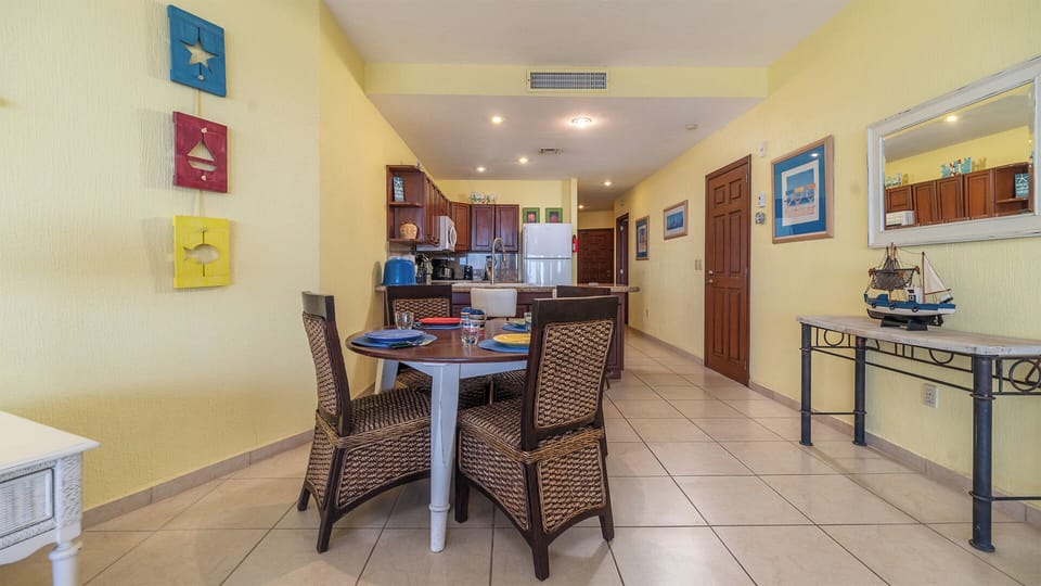 Dining table set by the complete kitchen.