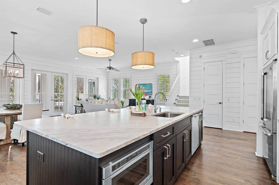 - Bright, open concept space brings everyone together from kitchen to cozy seating - Whip up meals on the spacious island while staying part of the conversation - Natural light, warm wood tones, and thoughtful details create the perfect backdrop