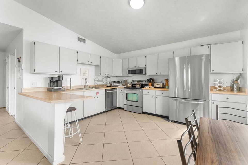 spacious kitchen with stainless steel appliances and ample counter space