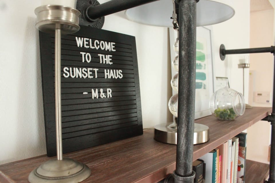 Welcome sign on a wooden shelf adds a personal touch to the space.