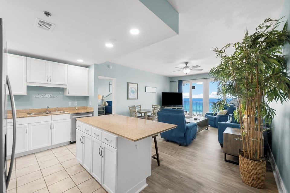 Open-concept kitchen and living area with ocean views and modern furnishings