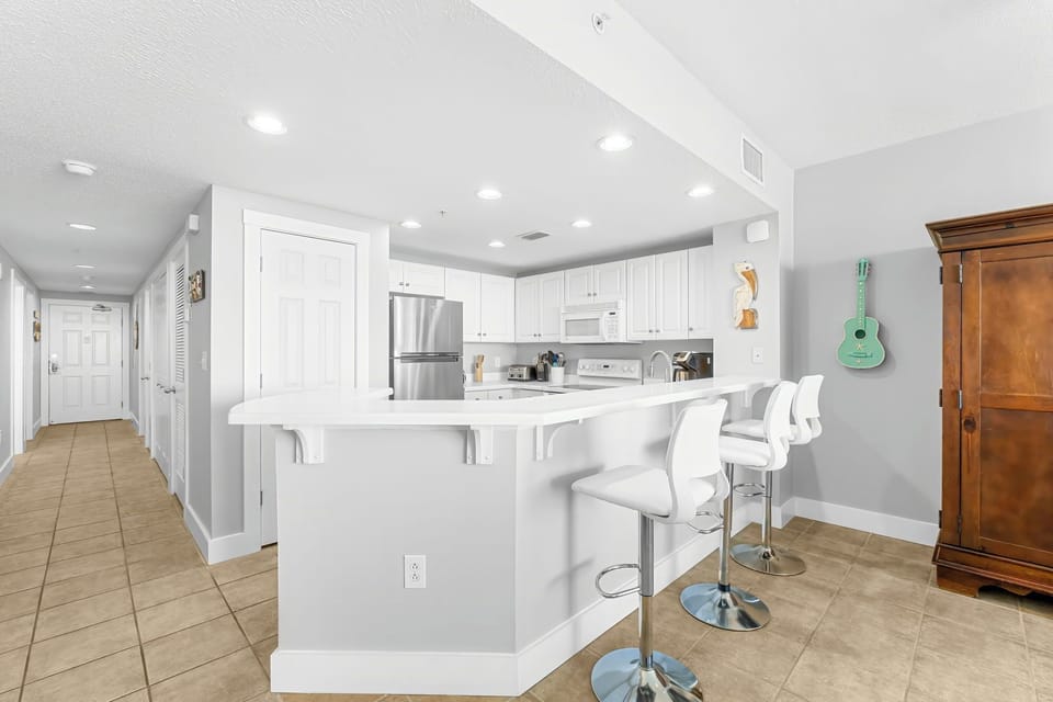 modern kitchen with white cabinetry and a breakfast bar with seating