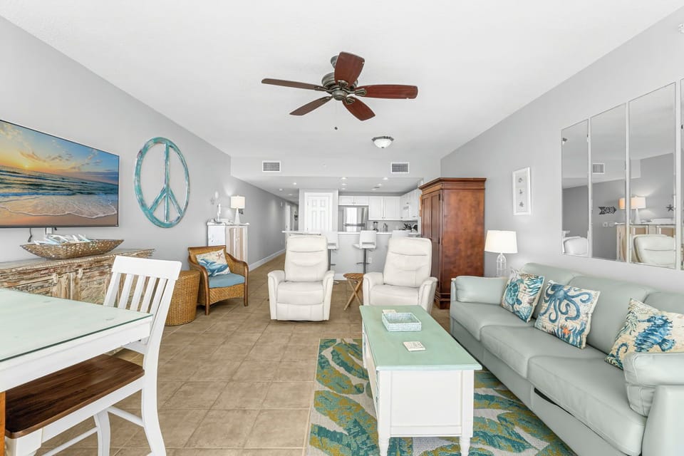 Spacious living area with coastal-inspired decor and comfortable seating.