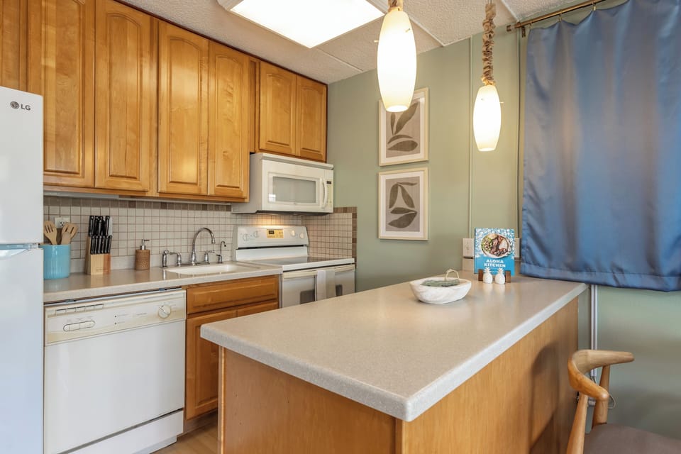 The fully equipped kitchen features modern appliances, generous counter space, and a convenient island—perfect for preparing meals, enjoying casual dining, or gathering with family and friends.