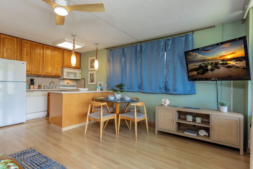 Enjoy the open-concept layout that seamlessly connects the kitchen, dining, and living areas, creating a comfortable and inviting space for gathering, dining, and relaxing during your Maui getaway.