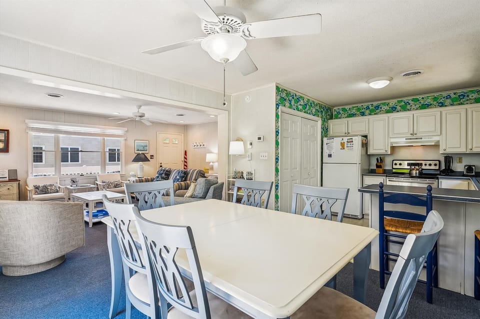 Gather your crew around this bright dining table, perfectly positioned between your fully equipped kitchen and inviting living room—designed for easy meals and vacation moments together.