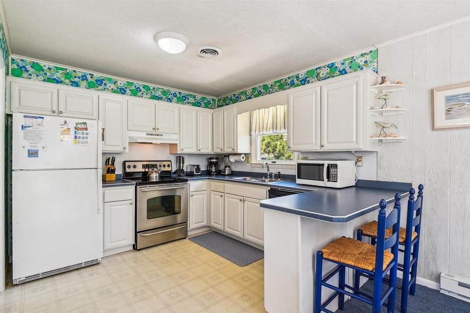 Cook your favorite meals in this fully-equipped kitchen, with plenty of counter space, modern appliances, and everything you need to feel right at home during your stay.