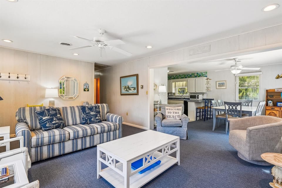 Settle into your coastal retreat—crisp blue stripes, nautical charm, and open-concept comfort invite you to unwind after sun-soaked days by the shore.