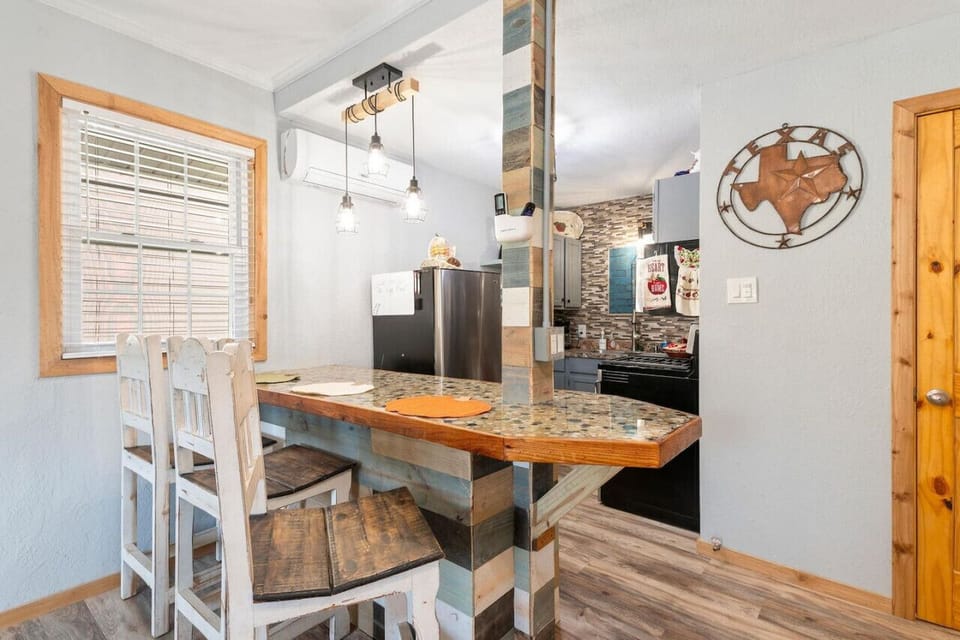 Beautifully designed bar with 3 high back wooden bar stools.