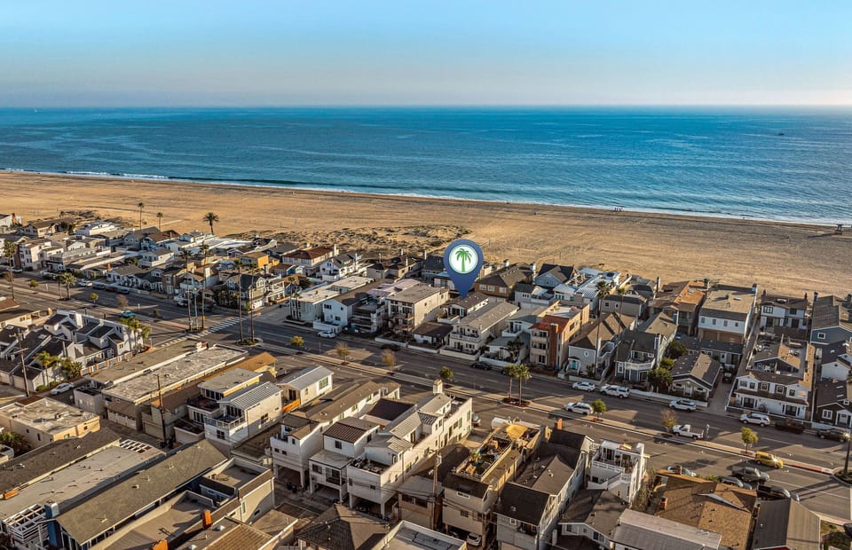 Aerial view showcasing the home’s prime location just steps from the sand
                