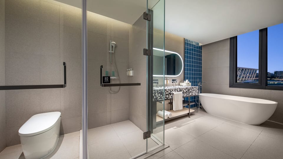 Suite, 1 King Bed | Bathroom | Slippers, towels