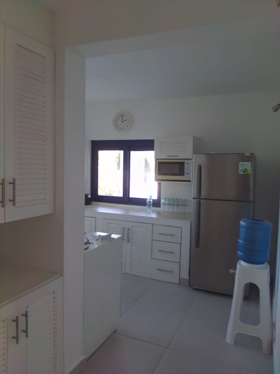 Galley kitchen with fridge freezer, gas stove, microwave, coffee maker, toaste