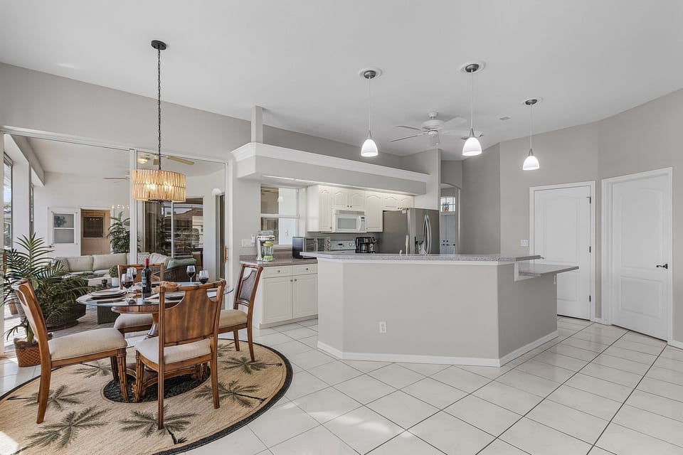 dining area with slider and window. pool views.