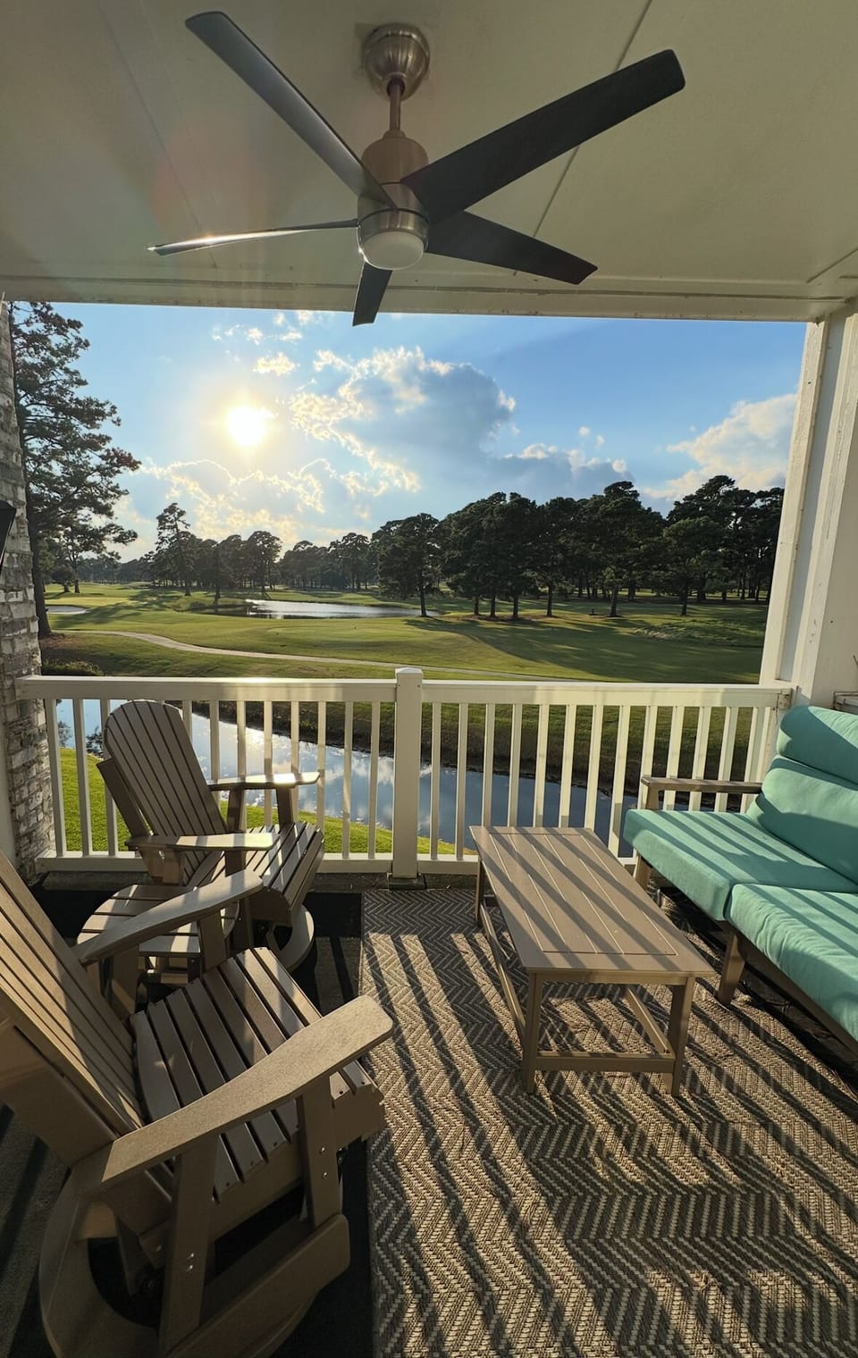 Porch w/  seating, ceiling fan and view of 4th hole 