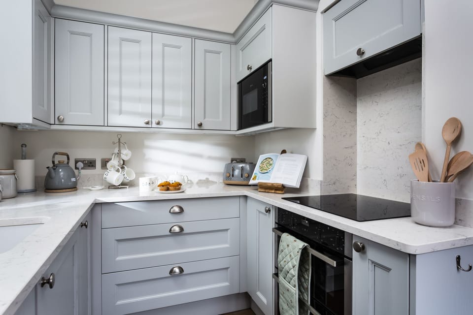 Electric range oven and hob in the well-equipped kitchen