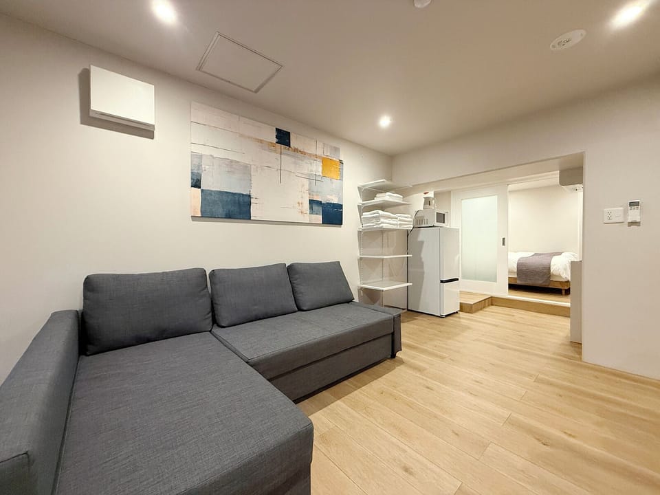 Comfort Apartment | Living area | 65-inch TV with digital channels