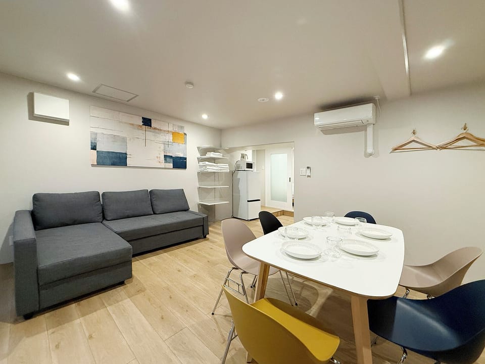 Comfort Apartment | Living area | 65-inch TV with digital channels