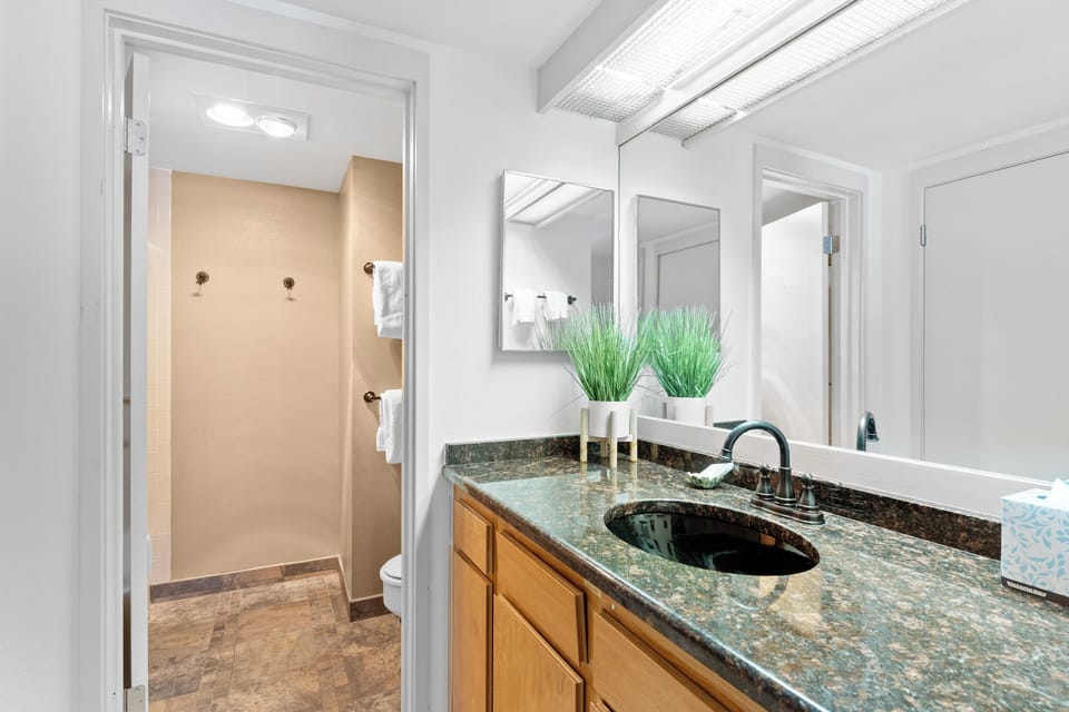 Your elegant bathroom features granite countertops, polished fixtures, and a spacious walk-in shower for ultimate comfort.
