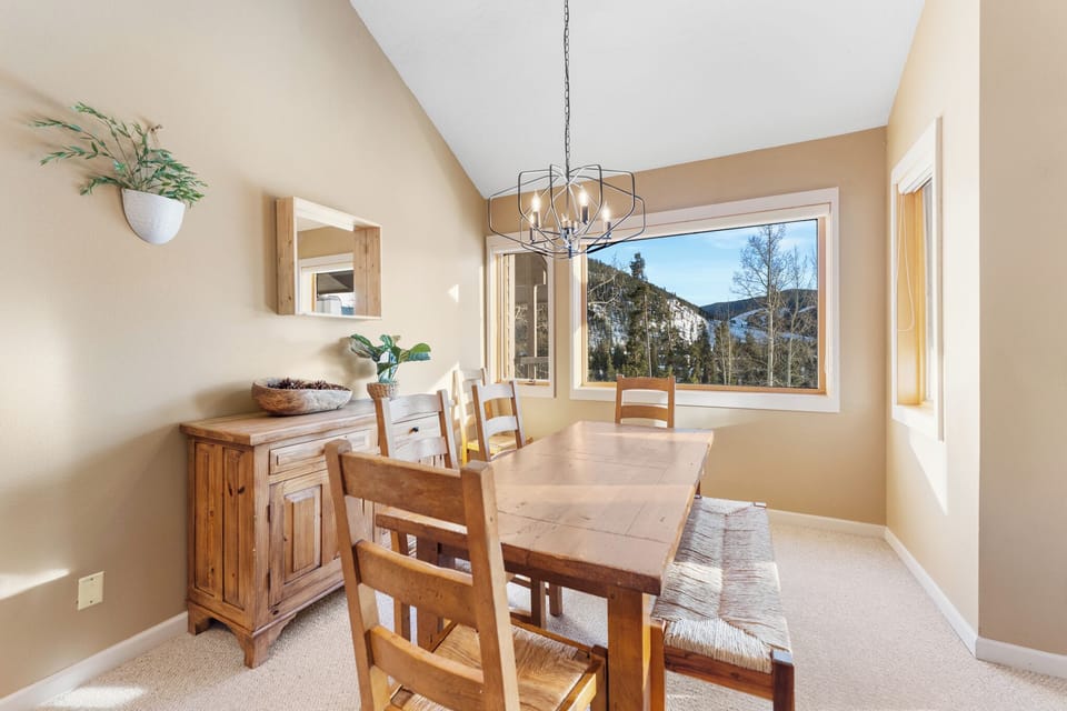 Share memorable meals around this cozy dining table while enjoying stunning mountain views through your picture window.
