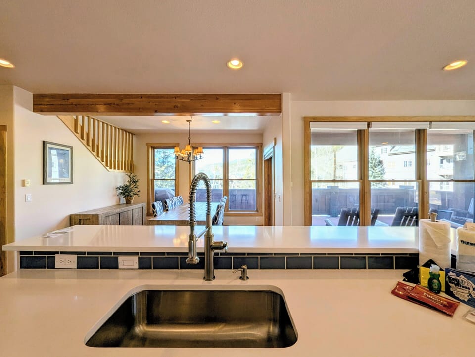 You'll love preparing meals in this bright, modern kitchen with gleaming countertops and warm wood accents throughout.