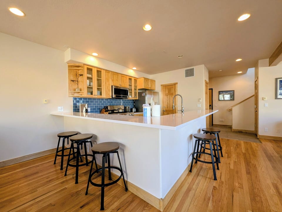 Gather around this inviting kitchen island with breakfast bar seating, perfect for morning coffee or evening conversations with loved ones.