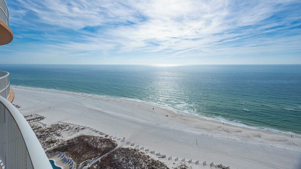 Listen to waves along the shore while standing on the balcony and gazing across the gulf