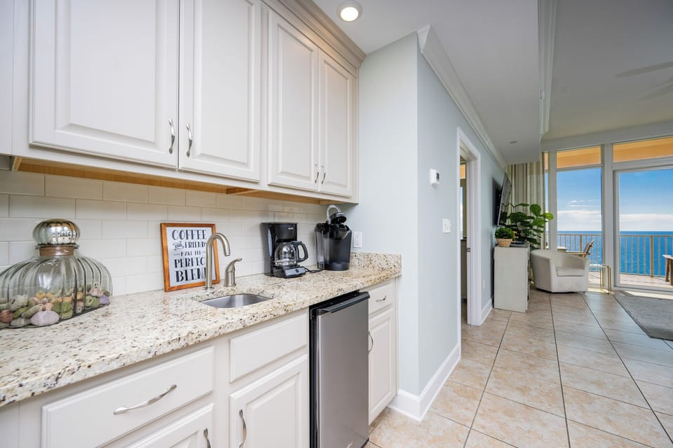 Savor your morning coffee at the wet bar, where refreshing views and coastal calm set the perfect tone for your day