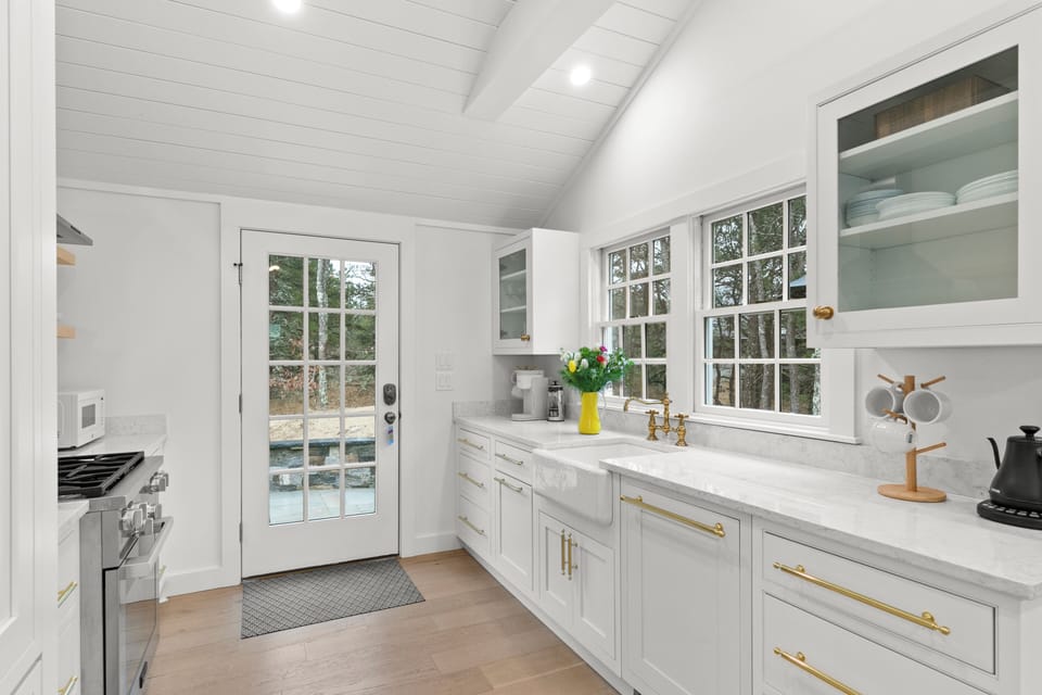 One side of the kitchen with the sink, dishwasher, and coffee/tea station
