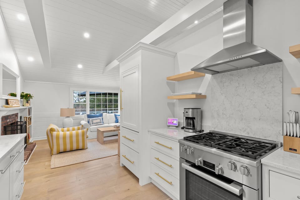 Other view of kitchen showcasing high-end Miele range and fridge