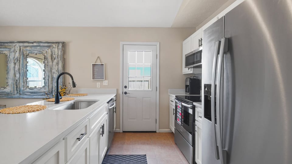 The kitchen door has a beautiful window for additional lighting.