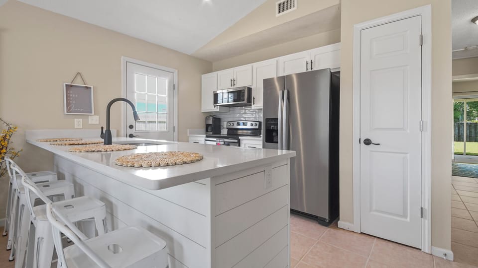 The newly remodeled kitchen has aditional seating around the island.