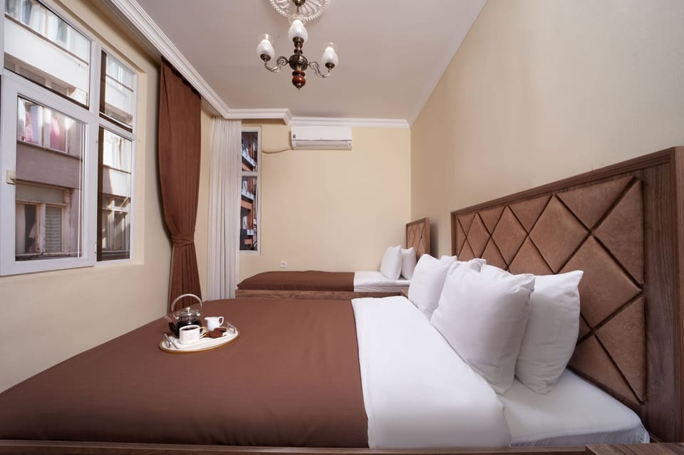Deluxe Triple Room, City View | In-room safe, iron/ironing board, free WiFi