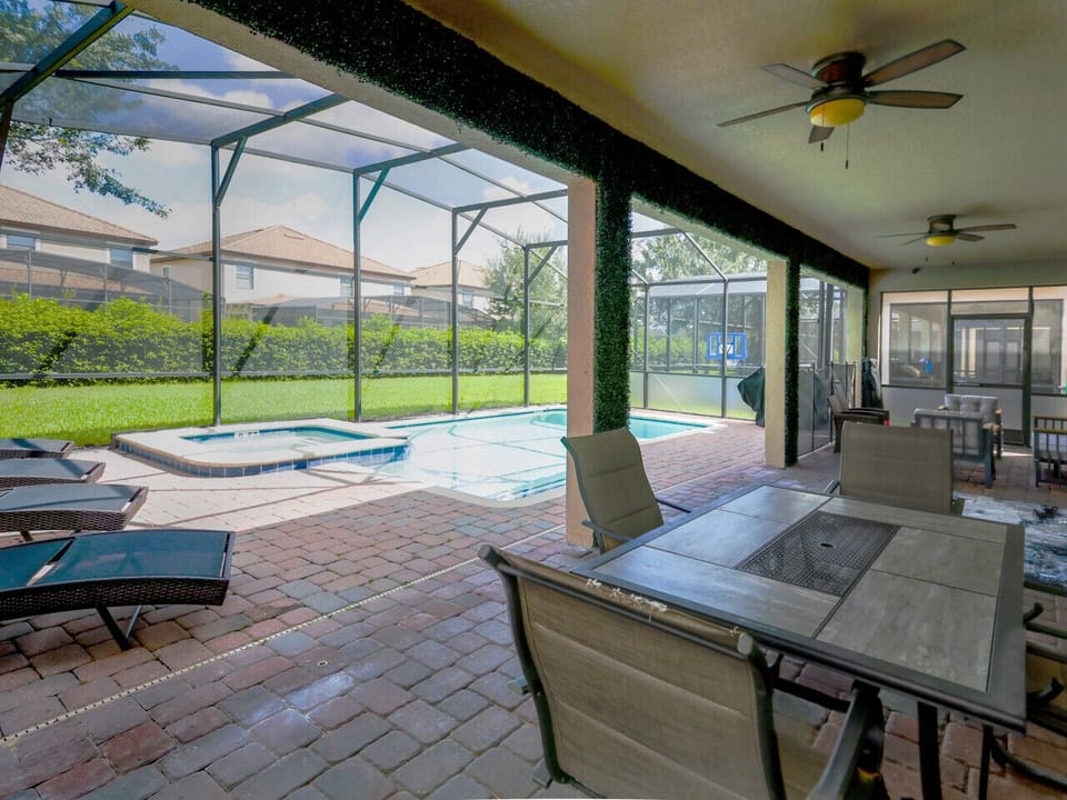 Covered patio dining next to the private pool
