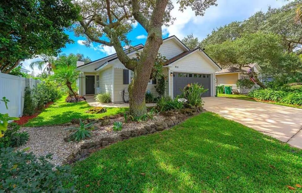 Charming home with lush landscaping and driveway parking