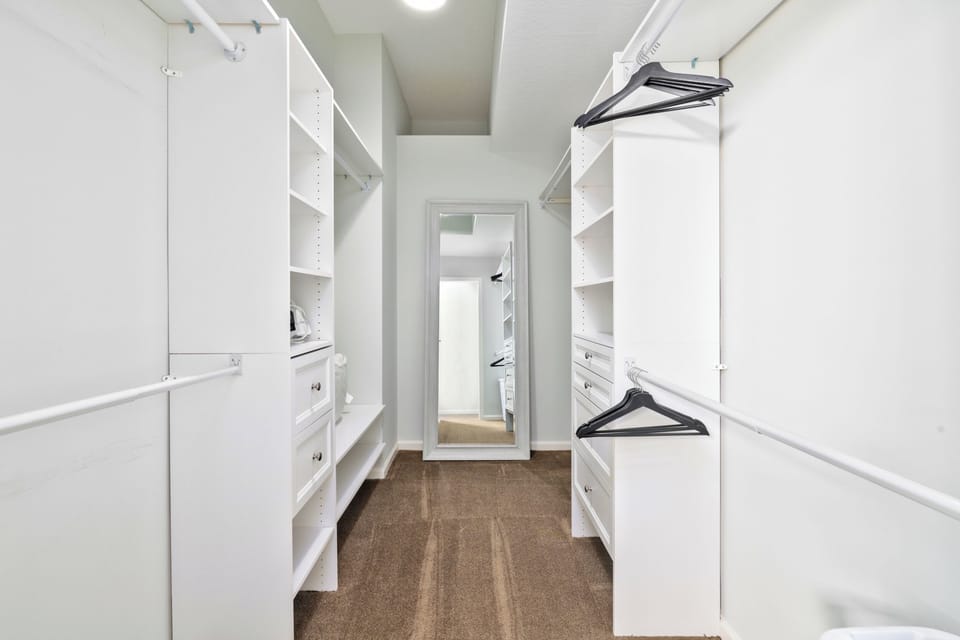 Primary closet with ample storage space