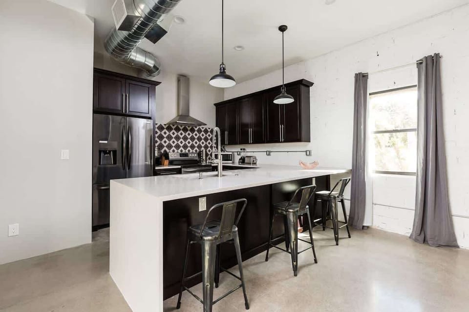 Cook and gather in this modern kitchen, complete with sleek stainless steel appliances and a stylish island with seating for 3—perfect for sharing meals or casual conversations.