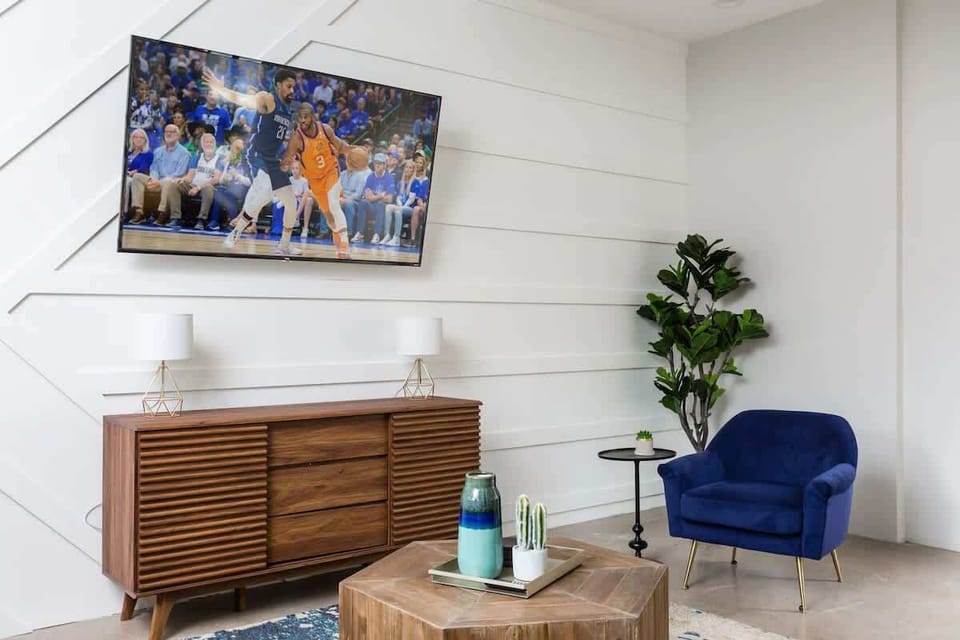 Relax in style with this spacious open-concept living room, featuring a cozy atmosphere and a smart TV for endless entertainment.