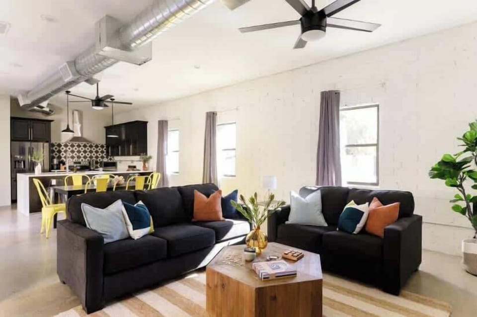 Relax in style with this spacious open-concept living room, featuring a cozy atmosphere and a smart TV for endless entertainment.