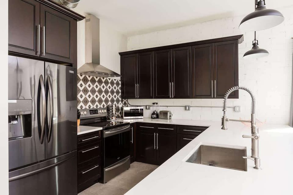 Cook and gather in this modern kitchen, complete with sleek stainless steel appliances and a stylish island with seating for 3—perfect for sharing meals or casual conversations.