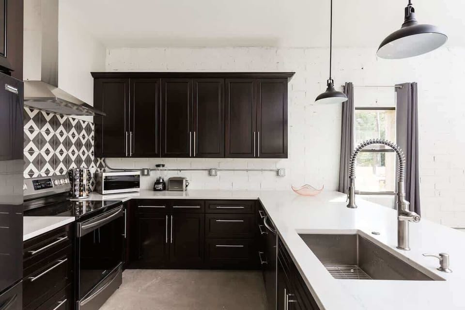 Cook and gather in this modern kitchen, complete with sleek stainless steel appliances and a stylish island with seating for 3—perfect for sharing meals or casual conversations.