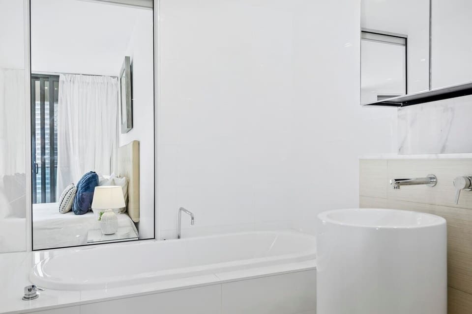 Ensuite bathroom off the master bedroom. Deep soaking bath, dual basins, toilet, and shower. 