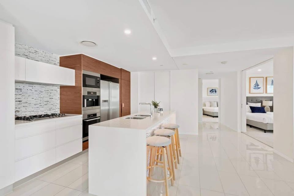 Modern, bright kitchen with European appliances and stone countertops.